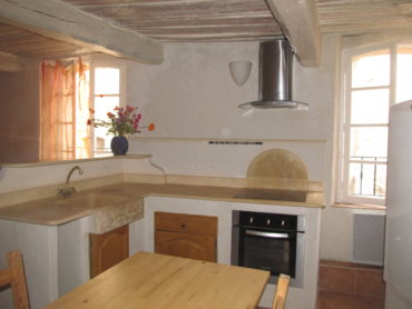 Aménagement intérieur d'une cuisine en pierre avec plan de travail et évier.